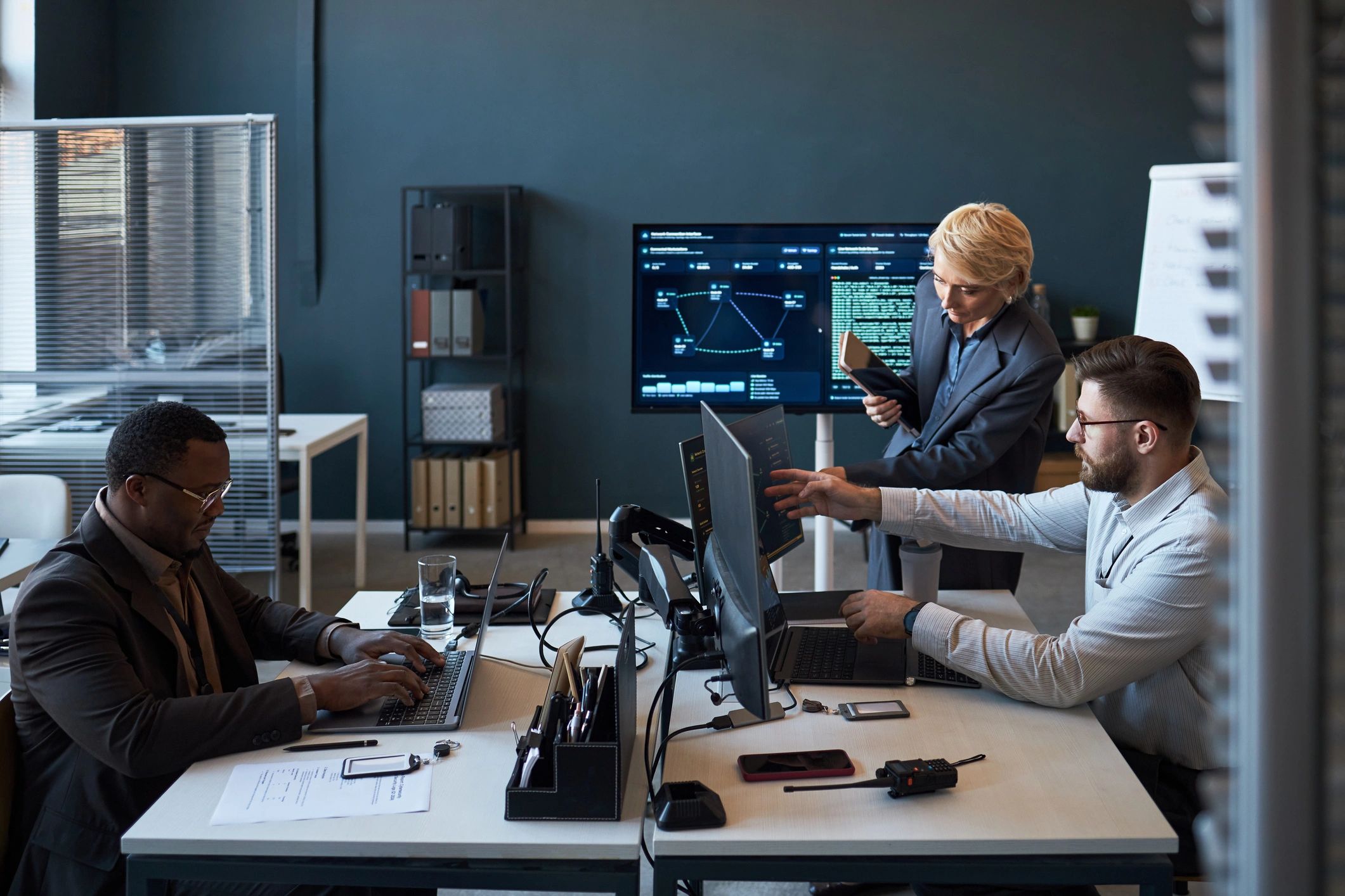 Business technology team reviewing digital dashboards in a modern office